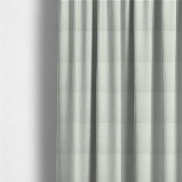 The fabric used to create these made-to-measure curtains is a textured upholstery fabric in a clean white or light ivory colour. The material features a subtle cross-hatched slub texture with fine vertical and horizontal ridges, creating a soft, dimensional chenille finish.
