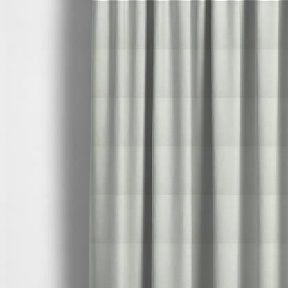 The fabric used to create these made-to-measure curtains is a textured upholstery fabric in a clean white or light ivory colour. The material features a subtle cross-hatched slub texture with fine vertical and horizontal ridges, creating a soft, dimensional chenille finish.