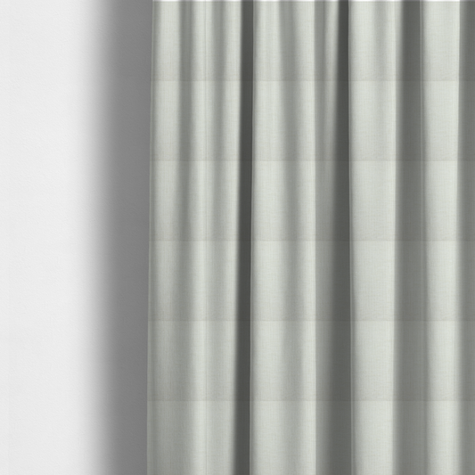 The fabric used to create these made-to-measure curtains is a textured upholstery fabric in a clean white or light ivory colour. The material features a subtle cross-hatched slub texture with fine vertical and horizontal ridges, creating a soft, dimensional chenille finish.