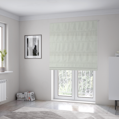 The fabric used to create these Roman blinds is a textured upholstery fabric in a clean white or light ivory colour. The material features a subtle cross-hatched slub texture with fine vertical and horizontal ridges, creating a soft, dimensional chenille finish.