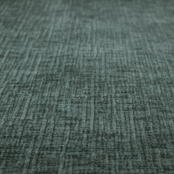 A textured upholstery fabric in a deep teal or eucalyptus green colour. The material features a distinct cross-hatched slub texture with subtle vertical and horizontal ridges, creating a soft, dimensional chenille finish.