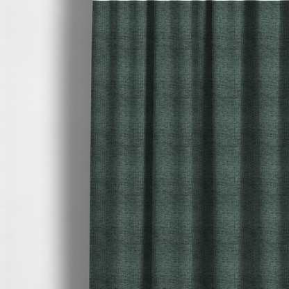 The fabric used to create these made-to-measure curtains is a textured upholstery fabric in a deep teal or eucalyptus green colour. The material features a distinct cross-hatched slub texture with subtle vertical and horizontal ridges, creating a soft, dimensional chenille finish.