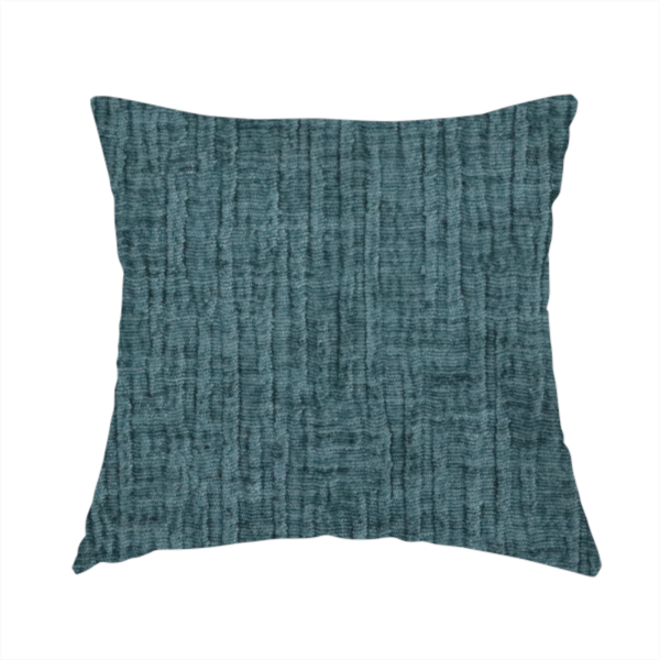 The fabric used to create this handmade cushion is a textured upholstery fabric in a vibrant peacock blue or deep teal shade. The material features a distinct cross-hatched slub texture with prominent vertical and fine horizontal ridges, creating a soft, dimensional chenille finish.