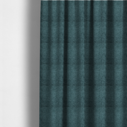 The fabric used to create these made-to-measure curtains is a textured upholstery fabric in a vibrant peacock blue or deep teal shade. The material features a distinct cross-hatched slub texture with prominent vertical and fine horizontal ridges, creating a soft, dimensional chenille finish.