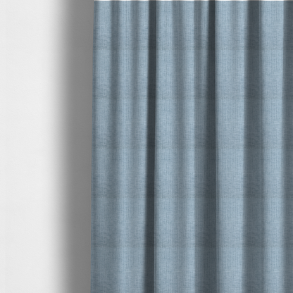 The fabric used to create these made-to-measure curtains is a textured upholstery fabric in a soft powder blue or light sky blue shade. The material features a distinct cross-hatched slub texture with subtle vertical and horizontal ridges, creating a soft, dimensional chenille finish.