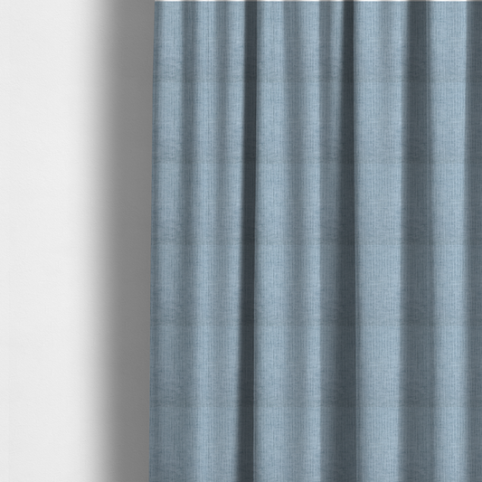 The fabric used to create these made-to-measure curtains is a textured upholstery fabric in a soft powder blue or light sky blue shade. The material features a distinct cross-hatched slub texture with subtle vertical and horizontal ridges, creating a soft, dimensional chenille finish.