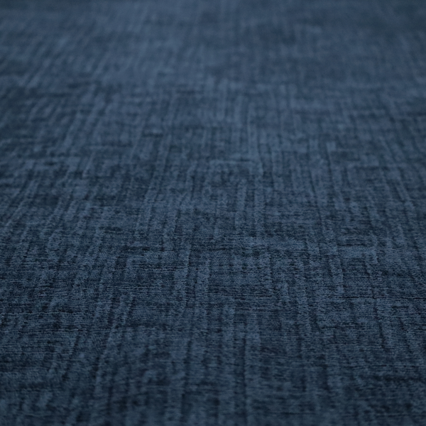 A textured upholstery fabric in a deep navy or midnight blue shade. The material features a distinct cross-hatched slub texture with prominent vertical and fine horizontal ridges, creating a soft, dimensional chenille finish.