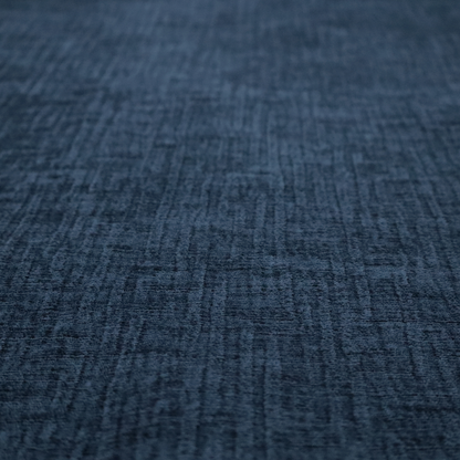 A textured upholstery fabric in a deep navy or midnight blue shade. The material features a distinct cross-hatched slub texture with prominent vertical and fine horizontal ridges, creating a soft, dimensional chenille finish.