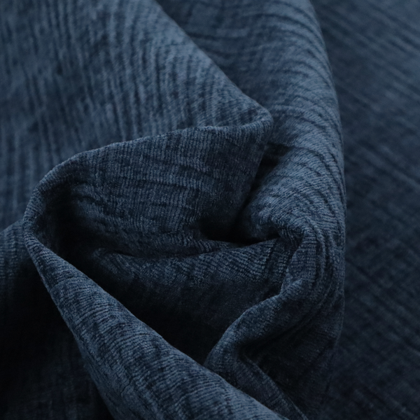 A textured upholstery fabric in a deep navy or midnight blue shade. The material features a distinct cross-hatched slub texture with prominent vertical and fine horizontal ridges, creating a soft, dimensional chenille finish.