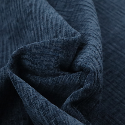 A textured upholstery fabric in a deep navy or midnight blue shade. The material features a distinct cross-hatched slub texture with prominent vertical and fine horizontal ridges, creating a soft, dimensional chenille finish.