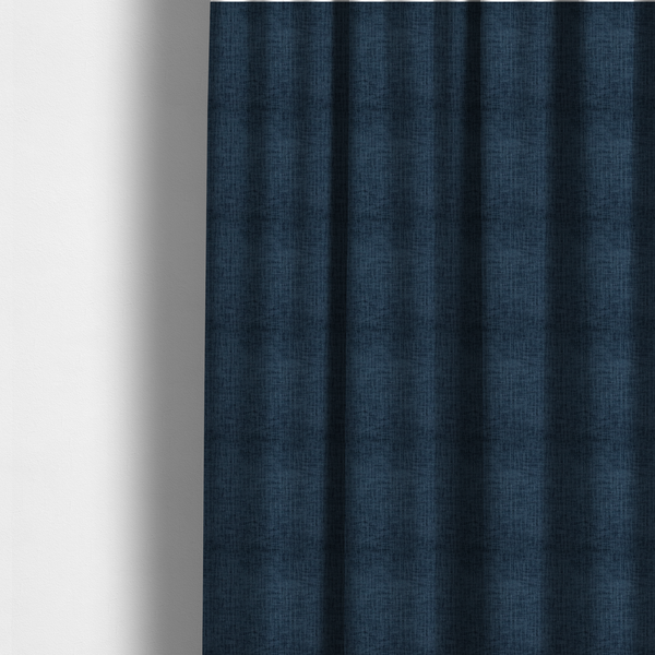 The fabric used to create these made-to-measure curtains is a textured upholstery fabric in a deep navy or midnight blue shade. The material features a distinct cross-hatched slub texture with prominent vertical and fine horizontal ridges, creating a soft, dimensional chenille finish.