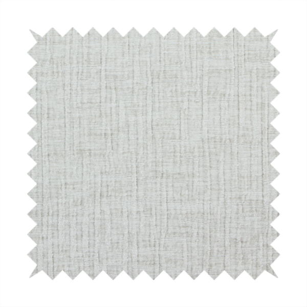 A textured upholstery fabric in a light silver or pale grey colour. The material features a subtle cross-hatched slub texture with fine vertical and horizontal ridges, creating a soft, dimensional chenille finish.