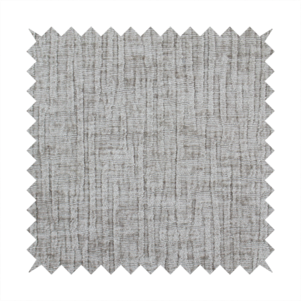 A textured upholstery fabric in a mid-tone grey or pebble shade. The material features a distinct cross-hatched slub texture with prominent vertical and fine horizontal ridges, creating a soft, dimensional chenille finish.