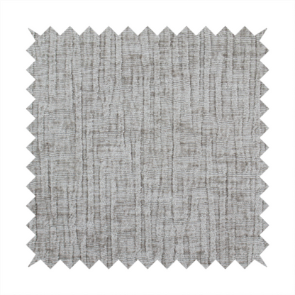 A textured upholstery fabric in a mid-tone grey or pebble shade. The material features a distinct cross-hatched slub texture with prominent vertical and fine horizontal ridges, creating a soft, dimensional chenille finish.