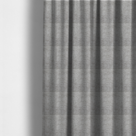 The fabric used to create these made-to-measure curtains is a textured upholstery fabric in a mid-tone grey or pebble shade. The material features a distinct cross-hatched slub texture with prominent vertical and fine horizontal ridges, creating a soft, dimensional chenille finish.