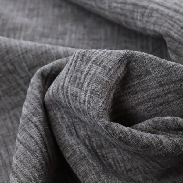 A textured upholstery fabric in a charcoal or dark grey shade. The material features a distinct cross-hatched slub texture with subtle vertical and horizontal ridges, creating a soft, dimensional chenille finish.
