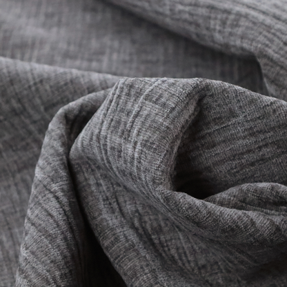 A textured upholstery fabric in a charcoal or dark grey shade. The material features a distinct cross-hatched slub texture with subtle vertical and horizontal ridges, creating a soft, dimensional chenille finish.