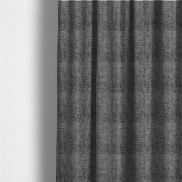 The fabric used to create these made-to-measure curtains is a textured upholstery fabric in a charcoal or dark grey shade. The material features a distinct cross-hatched slub texture with subtle vertical and horizontal ridges, creating a soft, dimensional chenille finish.