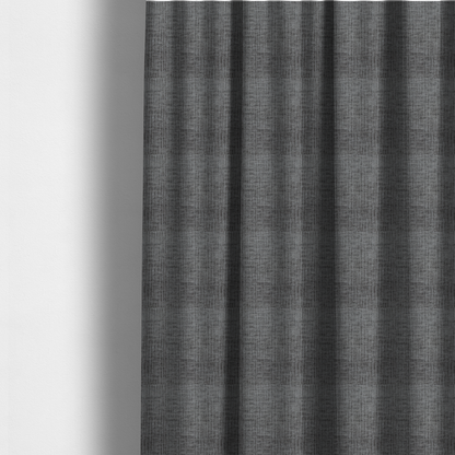 The fabric used to create these made-to-measure curtains is a textured upholstery fabric in a charcoal or dark grey shade. The material features a distinct cross-hatched slub texture with subtle vertical and horizontal ridges, creating a soft, dimensional chenille finish.
