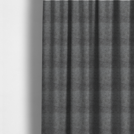 The fabric used to create these made-to-measure curtains is a textured upholstery fabric in a charcoal or dark grey shade. The material features a distinct cross-hatched slub texture with subtle vertical and horizontal ridges, creating a soft, dimensional chenille finish.
