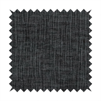 A textured upholstery fabric in a near-black or dark anthracite shade. The material features a distinct cross-hatched slub texture with prominent vertical and fine horizontal ridges, creating a soft, dimensional chenille finish.