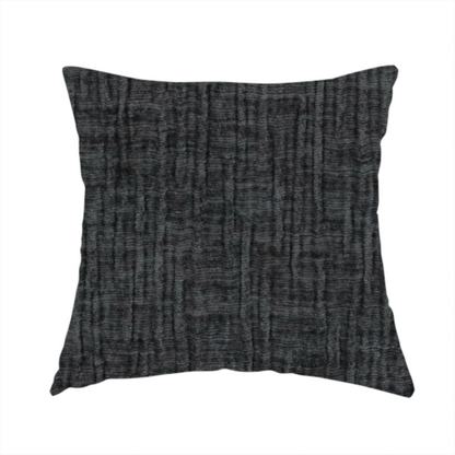 The fabric used to create this handmade cushion is a textured upholstery fabric in a near-black or dark anthracite shade. The material features a distinct cross-hatched slub texture with prominent vertical and fine horizontal ridges, creating a soft, dimensional chenille finish.
