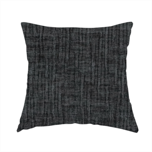 The fabric used to create this handmade cushion is a textured upholstery fabric in a near-black or dark anthracite shade. The material features a distinct cross-hatched slub texture with prominent vertical and fine horizontal ridges, creating a soft, dimensional chenille finish.