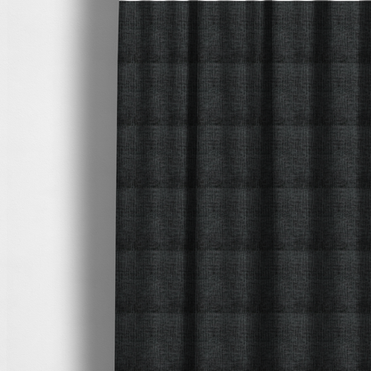 The fabric used to create these made-to-measure curtains is a textured upholstery fabric in a near-black or dark anthracite shade. The material features a distinct cross-hatched slub texture with prominent vertical and fine horizontal ridges, creating a soft, dimensional chenille finish.