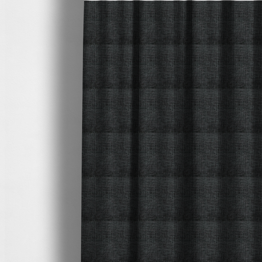 The fabric used to create these made-to-measure curtains is a textured upholstery fabric in a near-black or dark anthracite shade. The material features a distinct cross-hatched slub texture with prominent vertical and fine horizontal ridges, creating a soft, dimensional chenille finish.
