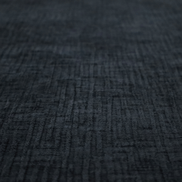 A textured upholstery fabric in a deep midnight black or very dark charcoal shade. The material features a distinct cross-hatched slub texture with subtle vertical and horizontal ridges, creating a soft, dimensional chenille finish.