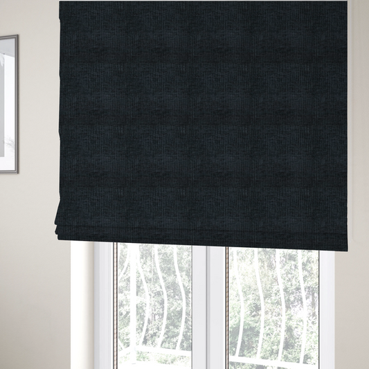The fabric used to create these Roman blinds is a textured upholstery fabric in a deep midnight black or very dark charcoal shade. The material features a distinct cross-hatched slub texture with subtle vertical and horizontal ridges, creating a soft, dimensional chenille finish