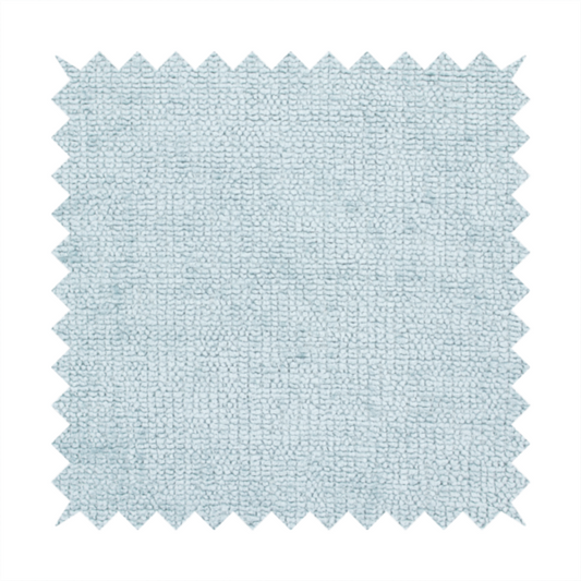 A textured fabric swatch in a soft, pale ice-blue colour. The material features a dense, uniform nubby weave or loop texture, resembling chenille, bouclé, or terry cloth, with subtle variations in shading that create a matte, soft appearance.