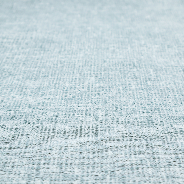 A textured fabric swatch in a soft, pale ice-blue colour. The material features a dense, uniform nubby weave or loop texture, resembling chenille, bouclé, or terry cloth, with subtle variations in shading that create a matte, soft appearance.