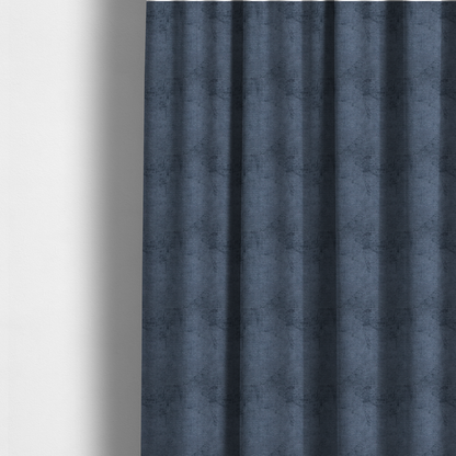 The fabric used to create these made-to-measure curtains is a textured fabric swatch in a deep slate blue or denim colour. The material features a dense, uniform nubby weave with subtle dark mottling throughout, giving the soft, textured surface a multi-tonal appearance.