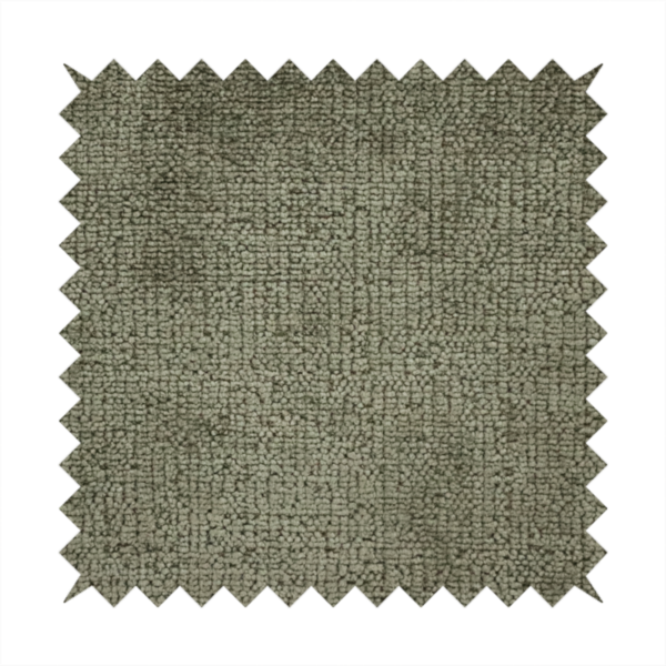 A textured fabric swatch in an earthy olive green or sage colour. The material features a dense, uniform nubby weave with subtle dark mottling throughout, giving the soft, textured surface a multi-tonal, organic appearance.