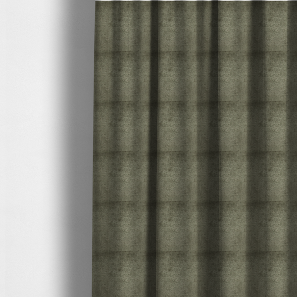 The fabric used to create these made-to-measure curtains is a textured fabric swatch in an earthy olive green or sage colour. The material features a dense, uniform nubby weave with subtle dark mottling throughout, giving the soft, textured surface a multi-tonal, organic appearance.