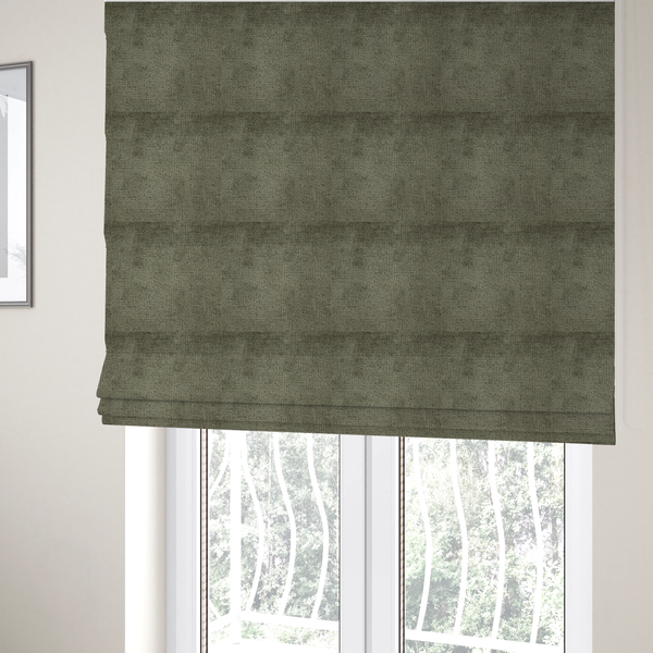 The fabric used to create these Roman blinds is a textured fabric swatch in an earthy olive green or sage colour. The material features a dense, uniform nubby weave with subtle dark mottling throughout, giving the soft, textured surface a multi-tonal, organic appearance.