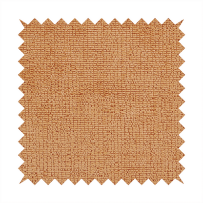 A textured fabric swatch in a warm terracotta or burnt orange colour. The material features a dense, uniform nubby weave with a soft, matte appearance, resembling chenille or bouclé cloth.
