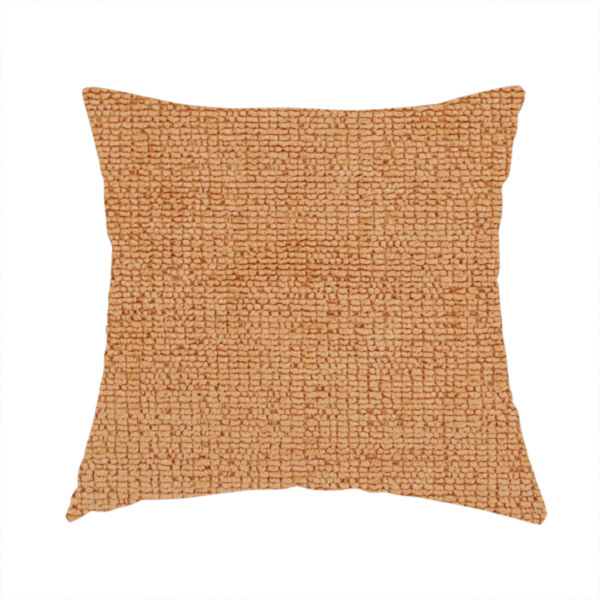 The fabric used to create this handmade cushion is a textured fabric swatch in a warm terracotta or burnt orange colour. The material features a dense, uniform nubby weave with a soft, matte appearance, resembling chenille or bouclé cloth.