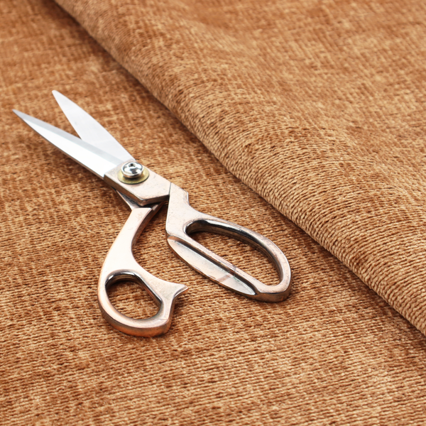A textured fabric swatch in a warm terracotta or burnt orange colour. The material features a dense, uniform nubby weave with a soft, matte appearance, resembling chenille or bouclé cloth.