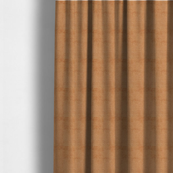 The fabric used to create these made-to-measure curtains is a textured fabric swatch in a warm terracotta or burnt orange colour. The material features a dense, uniform nubby weave with a soft, matte appearance, resembling chenille or bouclé cloth.