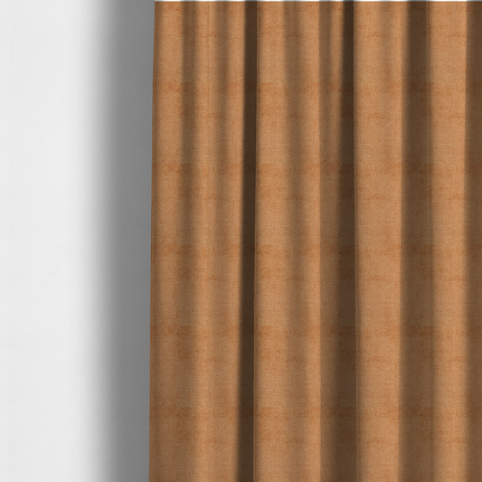 The fabric used to create these made-to-measure curtains is a textured fabric swatch in a warm terracotta or burnt orange colour. The material features a dense, uniform nubby weave with a soft, matte appearance, resembling chenille or bouclé cloth.