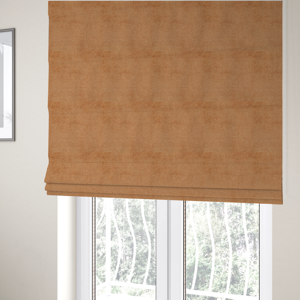 The fabric used to create these Roman blinds is a textured fabric swatch in a warm terracotta or burnt orange colour. The material features a dense, uniform nubby weave with a soft, matte appearance, resembling chenille or bouclé cloth.