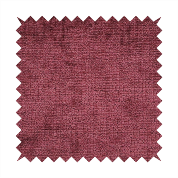 A textured fabric swatch in a rich berry red, burgundy, or mauve colour. The material features a dense, uniform nubby weave with subtle dark variations and shading, giving the soft surface a multi-tonal, deep appearance.