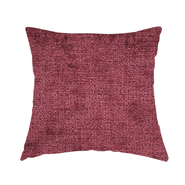 The fabric used to create this handmade cushion is a textured fabric swatch in a rich berry red, burgundy, or mauve colour. The material features a dense, uniform nubby weave with subtle dark variations and shading, giving the soft surface a multi-tonal, deep appearance.
