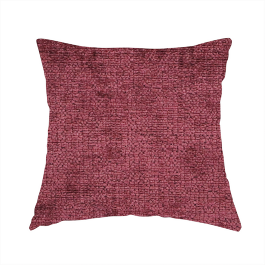 The fabric used to create this handmade cushion is a textured fabric swatch in a rich berry red, burgundy, or mauve colour. The material features a dense, uniform nubby weave with subtle dark variations and shading, giving the soft surface a multi-tonal, deep appearance.