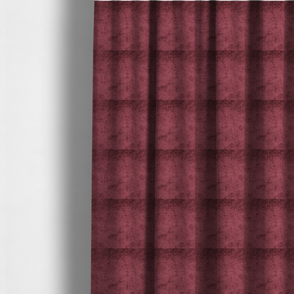 The fabric used to create these made-to-measure curtains is a textured fabric swatch in a rich berry red, burgundy, or mauve colour. The material features a dense, uniform nubby weave with subtle dark variations and shading, giving the soft surface a multi-tonal, deep appearance.