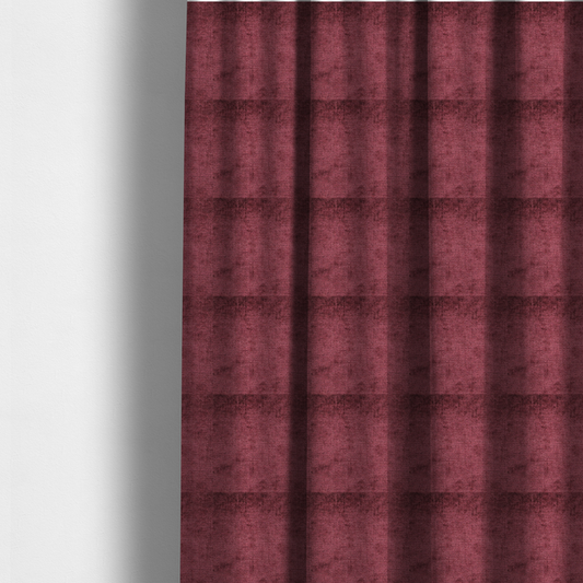 The fabric used to create these made-to-measure curtains is a textured fabric swatch in a rich berry red, burgundy, or mauve colour. The material features a dense, uniform nubby weave with subtle dark variations and shading, giving the soft surface a multi-tonal, deep appearance.