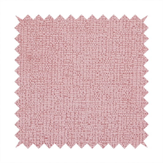 A textured fabric swatch in a soft, dusty pink or rose colour. The material features a dense, uniform nubby weave with a matte finish, creating a gentle and welcoming appearance.