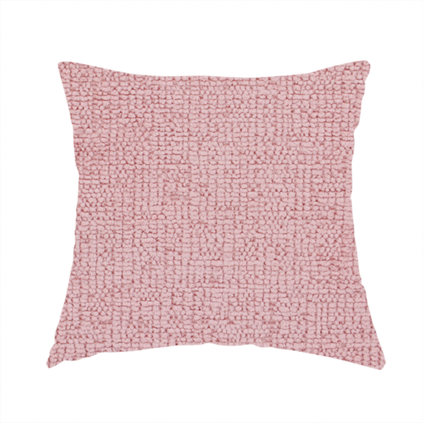 The fabric used to create this handmade cushion is a textured fabric swatch in a soft, dusty pink or rose colour. The material features a dense, uniform nubby weave with a matte finish, creating a gentle and welcoming appearance.